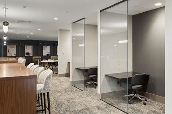 A conference room with white walls and glass doors
